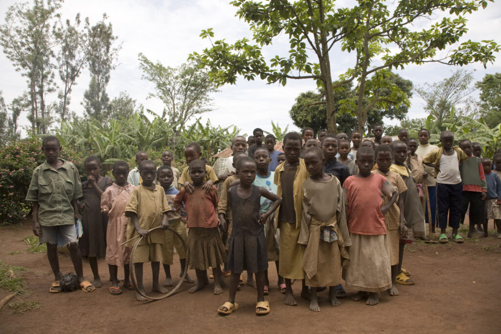 Group of children gathering with curiosity in a rural setting